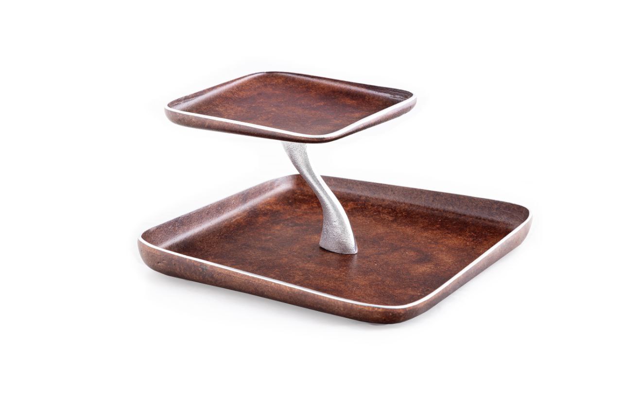 A rectangular, two-tier brown serving tray with a minimalistic design, featuring a lighter colored handle and stand.