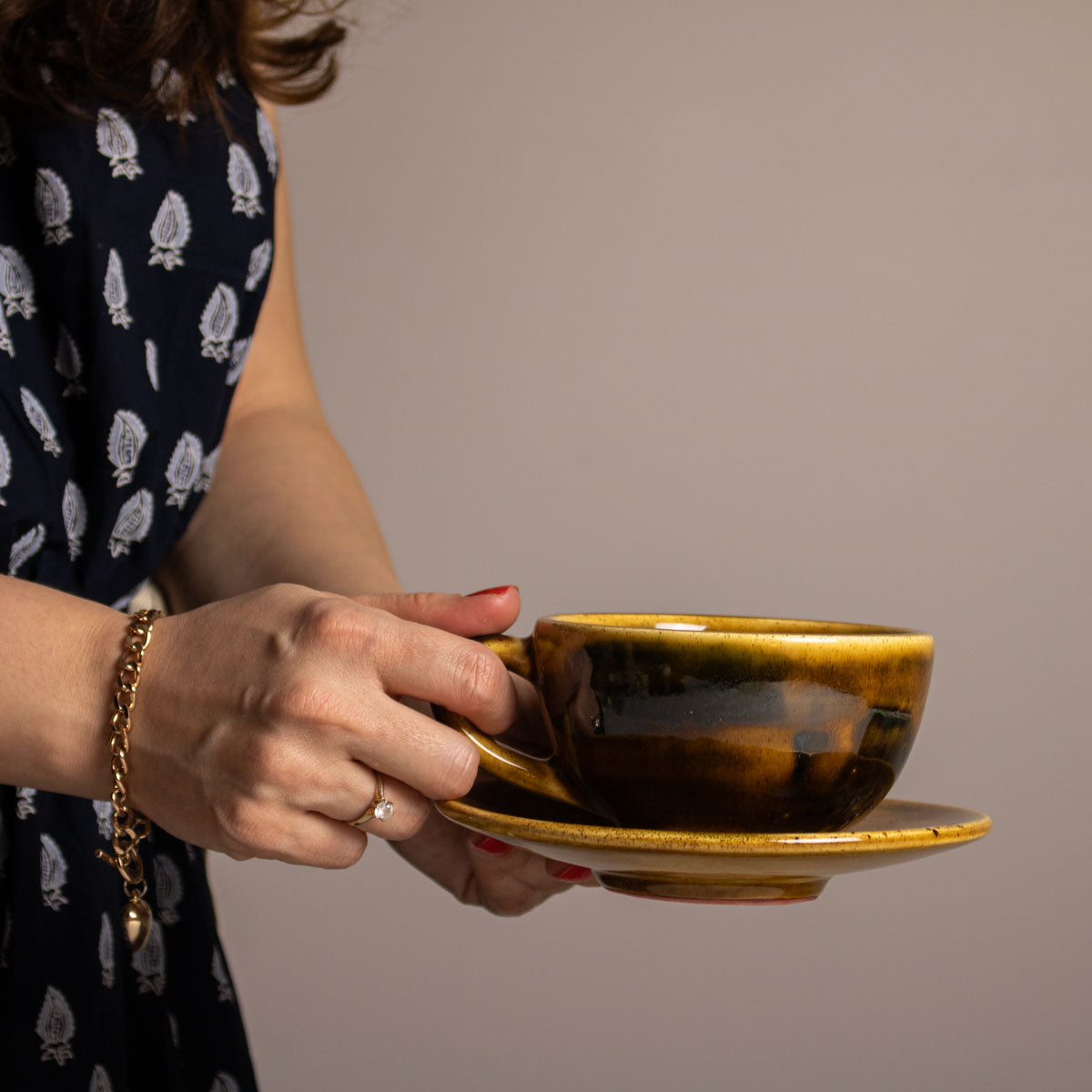 Brown Ceramic Cup and Plate in Hand
